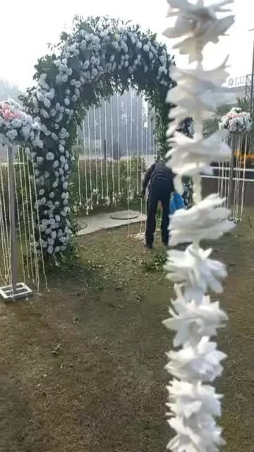 White floral arch for an outdoor Nikah